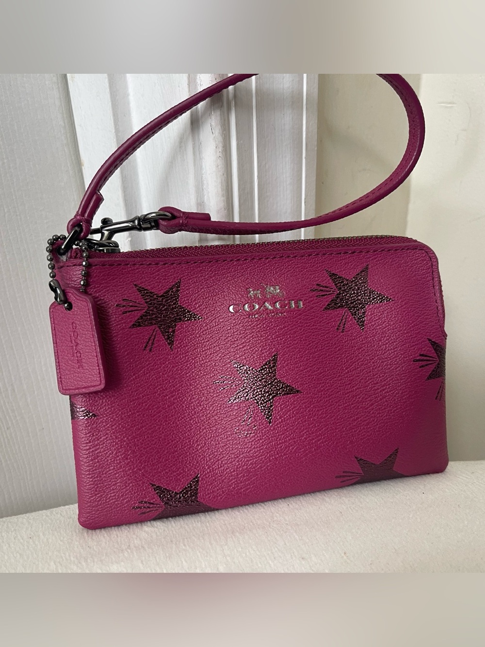 Coach Fuchsia Star Leather Wristlet with Gunmetal hardware.
